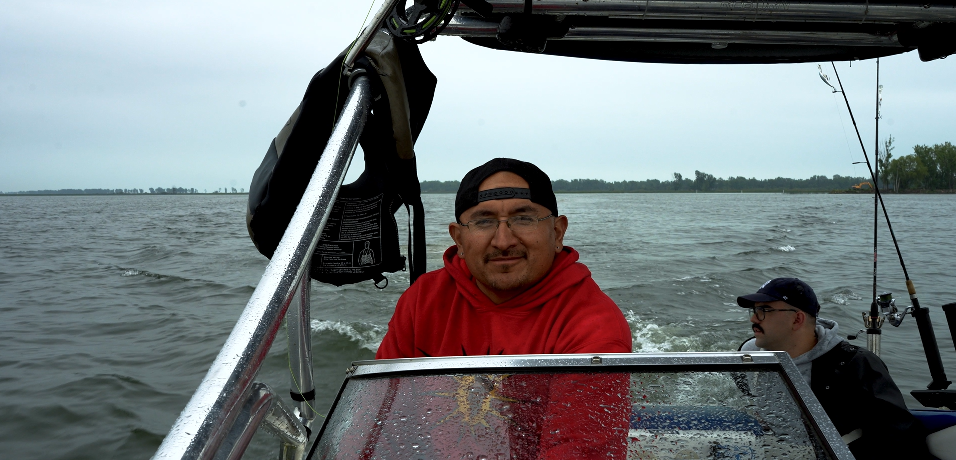 Two people in boat on choppy water in Indigenous Network documentary