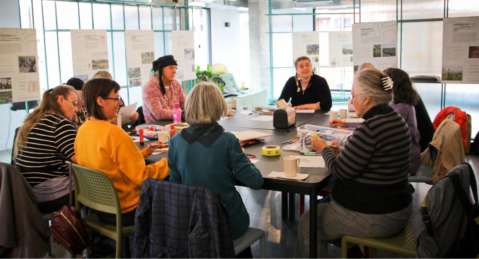 a group of people around a table talking